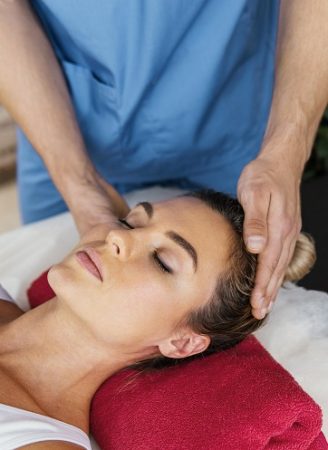 high angle male osteopathic therapist checking female patient s neck spine