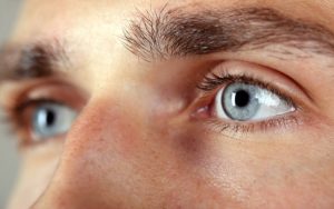 Close-up of blue eyes in a male, illustrating clear and sharp eyesight.